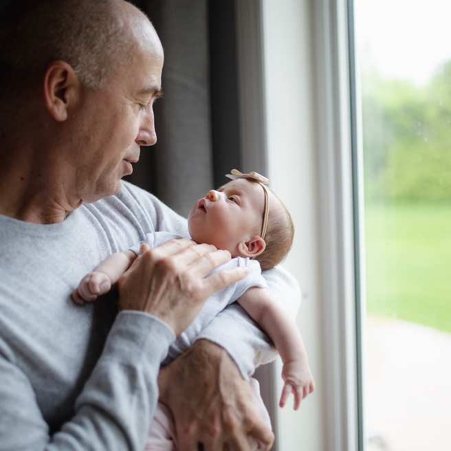 Grandfather holding a newborn